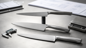Stainless-steel kitchen knives arranged for a surface-finish sample review